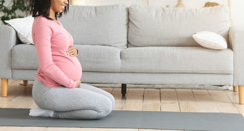 Cropped profile photo of pregnant woman exercising at home
