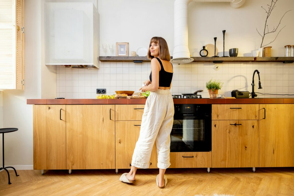Woman with healthy food in kitchen at home